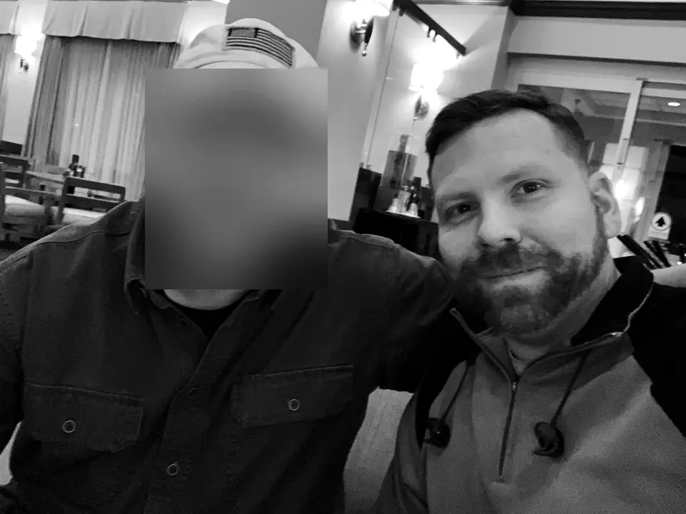 Craig Smith with a colleague in a hotel lobby; colleague’s face obscured