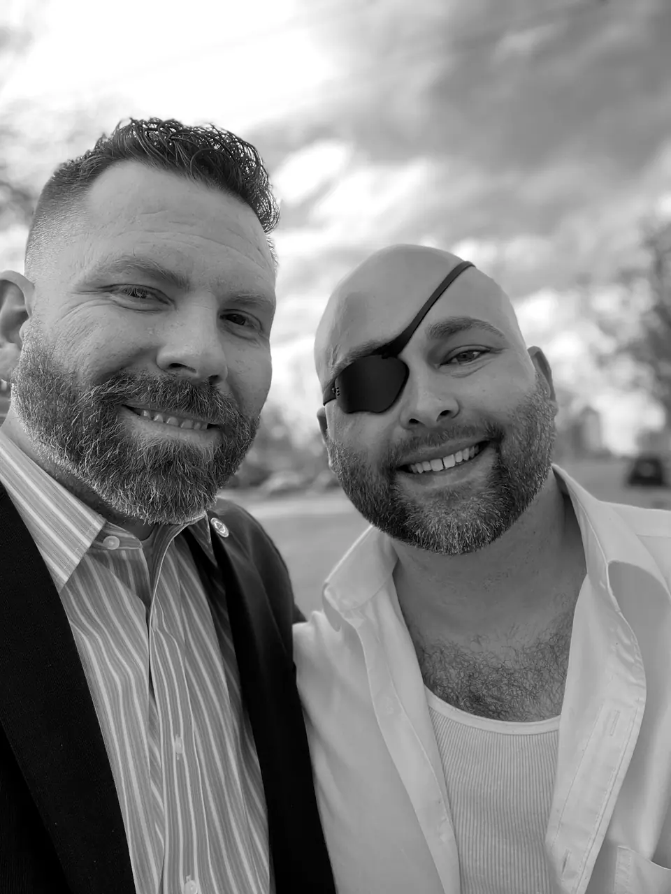 Craig Smith with John Lott: selfie outdoors, Craig in a suit